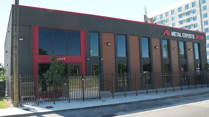 Red entrance portal of the Metal Experts Group building