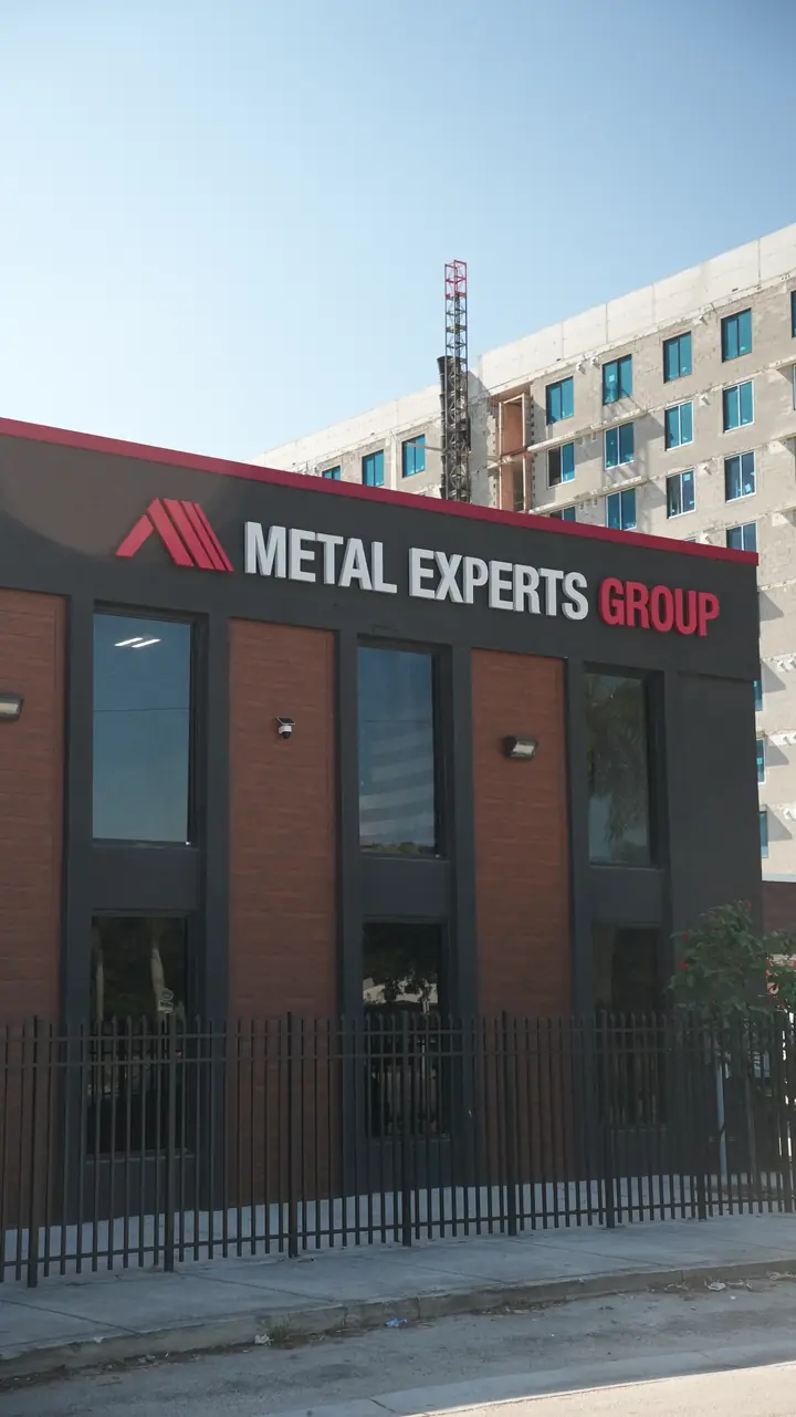 Upper facade band with brick-look metal panels and signage