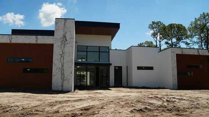 Wide view with cladding volumes and stone-style columns