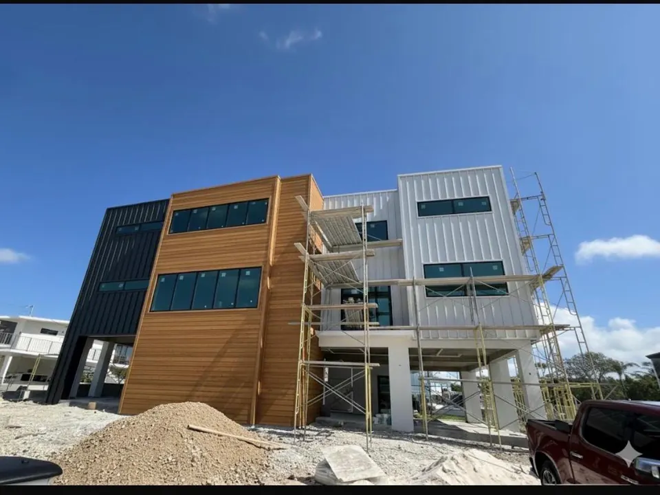 Multi-level residence during wood-look metal panel installation
