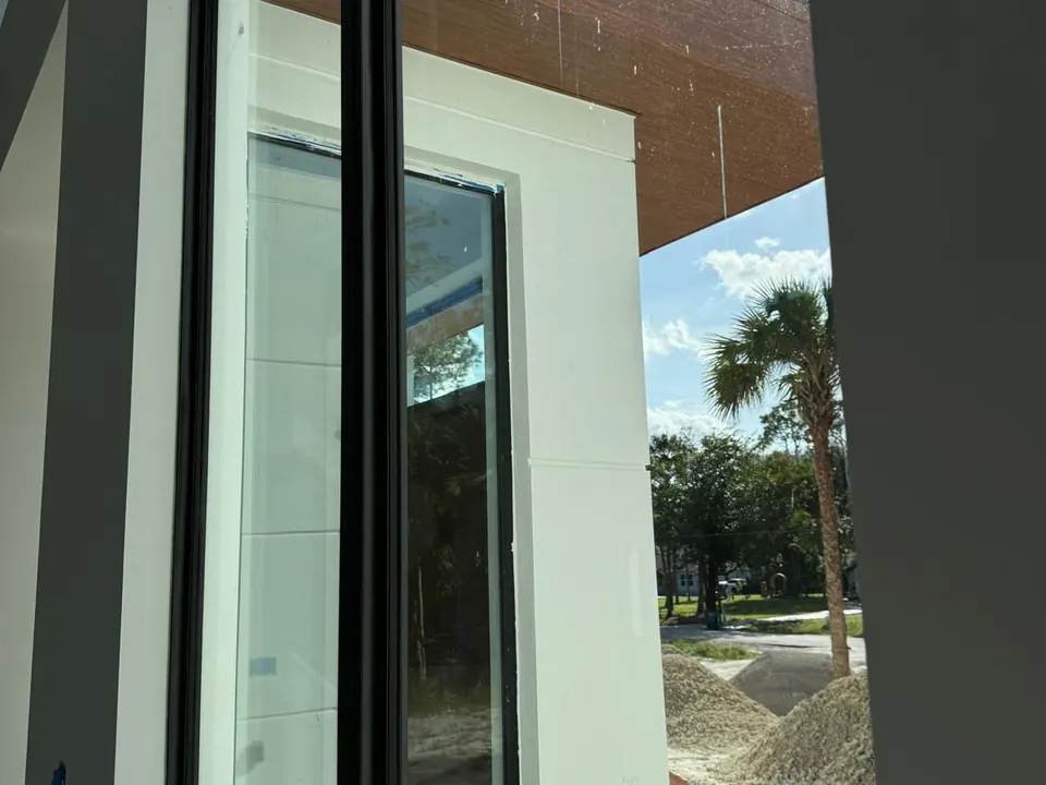 Wood-look exterior trim beside floor-to-ceiling glass