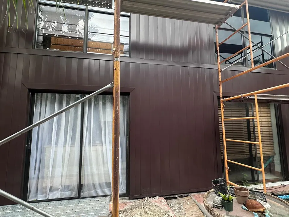 Vertical siding and wood-look panel installation